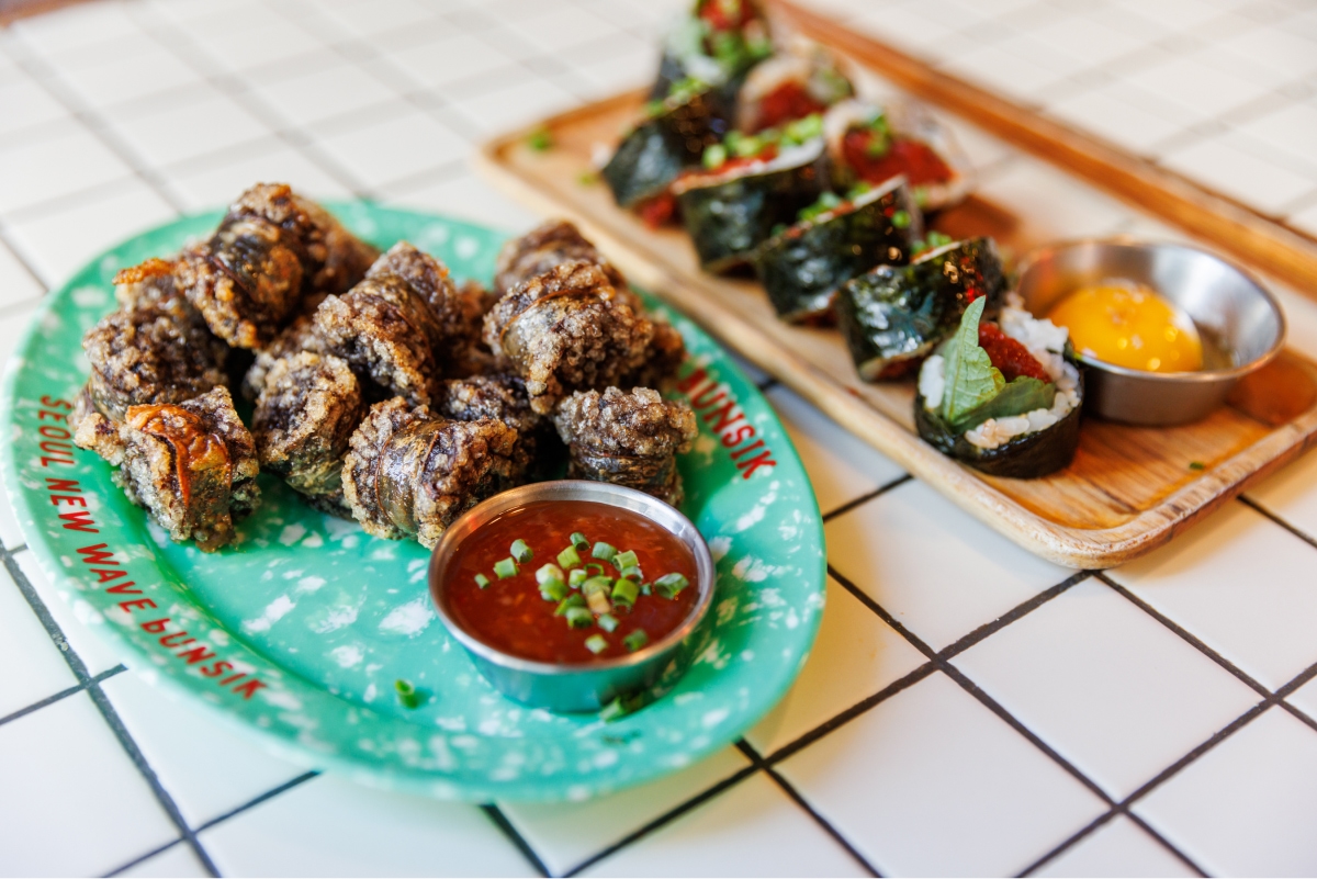 A picture of sundae and gimbap on a plate